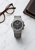 Hublot Big Bang Grey Skeleton Chronograph watch with grey leather strap on marble table