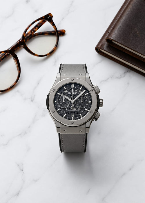 Hublot Big Bang Grey Skeleton Chronograph watch with grey leather strap on marble table